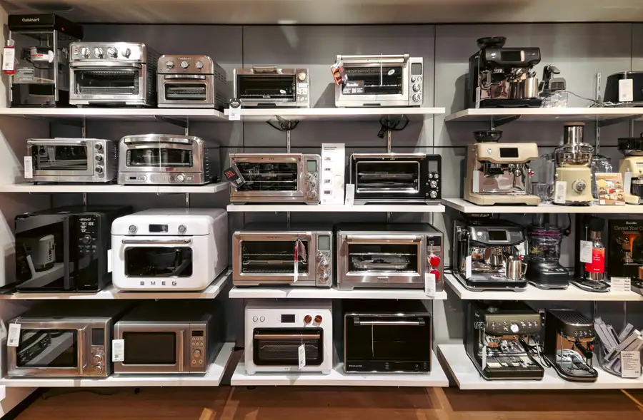 An image of a commercial kitchen with various deep fryer models on display
