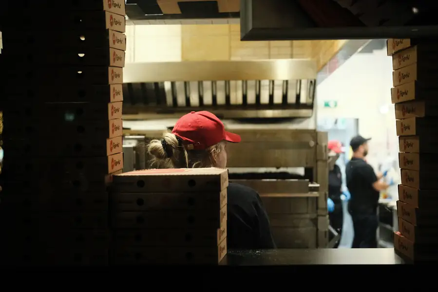 A chef using a combi oven in a busy kitchen