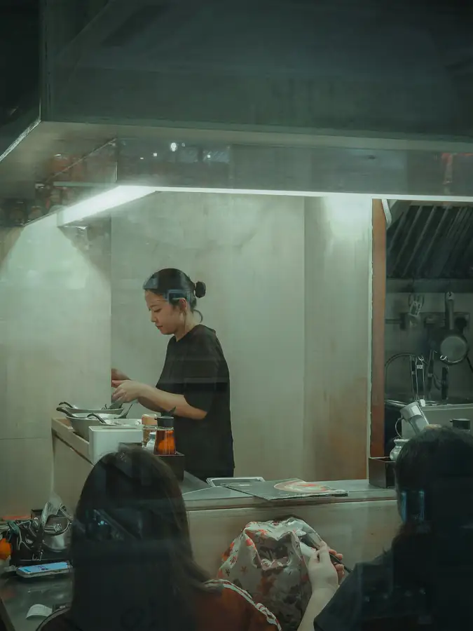 Restaurant owner proudly stands in a newly equipped kitchen