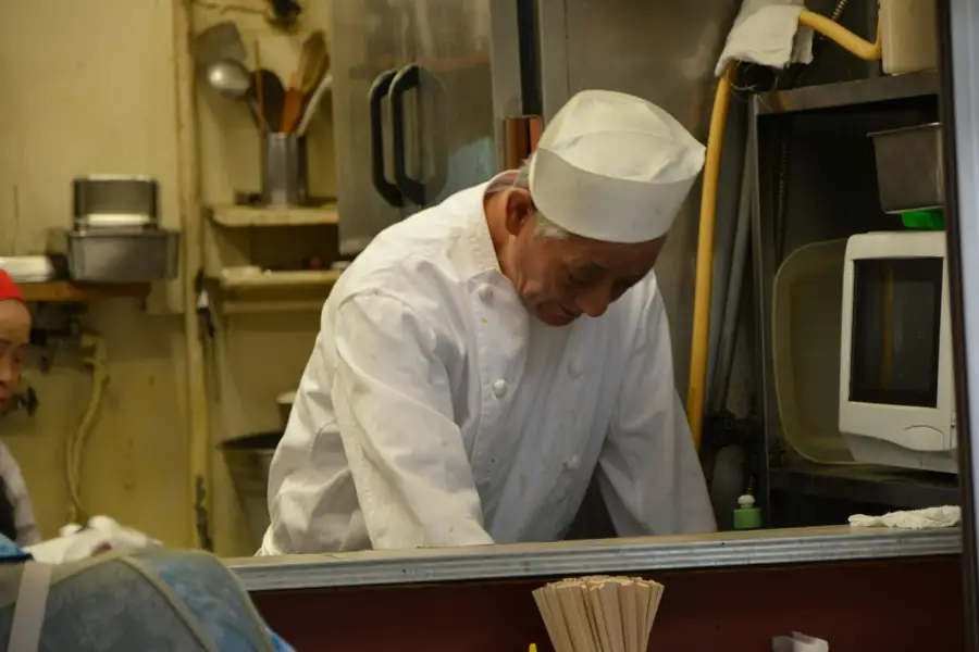 An image showing a chef discussing equipment with a supplier representative