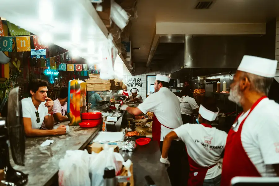 A bustling restaurant kitchen with a commercial refrigerator