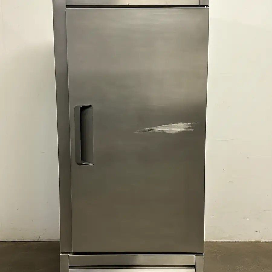 A simple photo of a "scratch and dent" commercial refrigerator, with a visible but purely cosmetic scuff on the side door