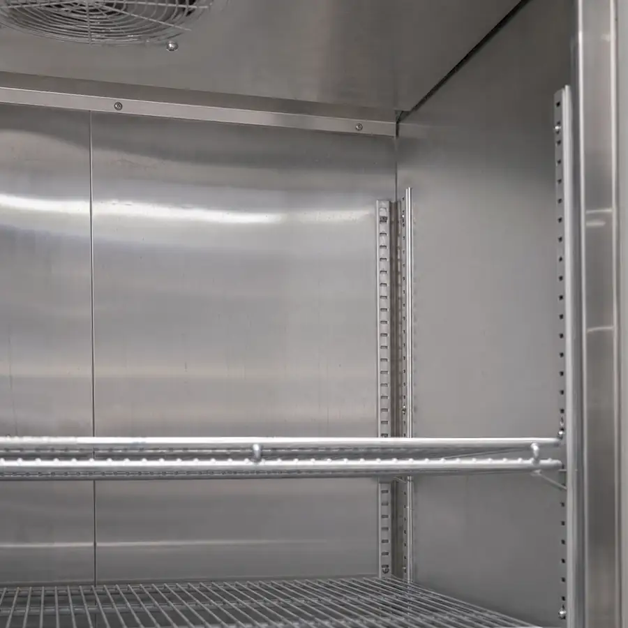 Close up of a stainless steel interior of a commercial reach-in refrigerator