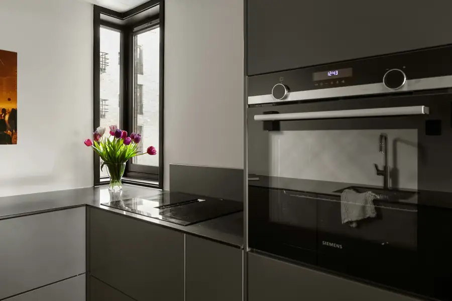 Modern kitchen with digital order screens and smart cooking equipment