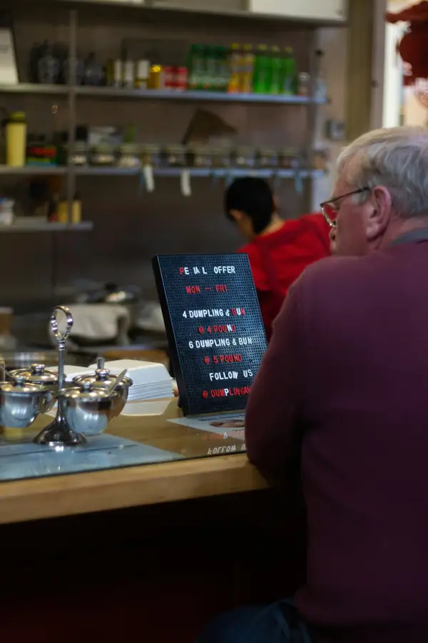 Restaurant owner discussing equipment options with a supplier