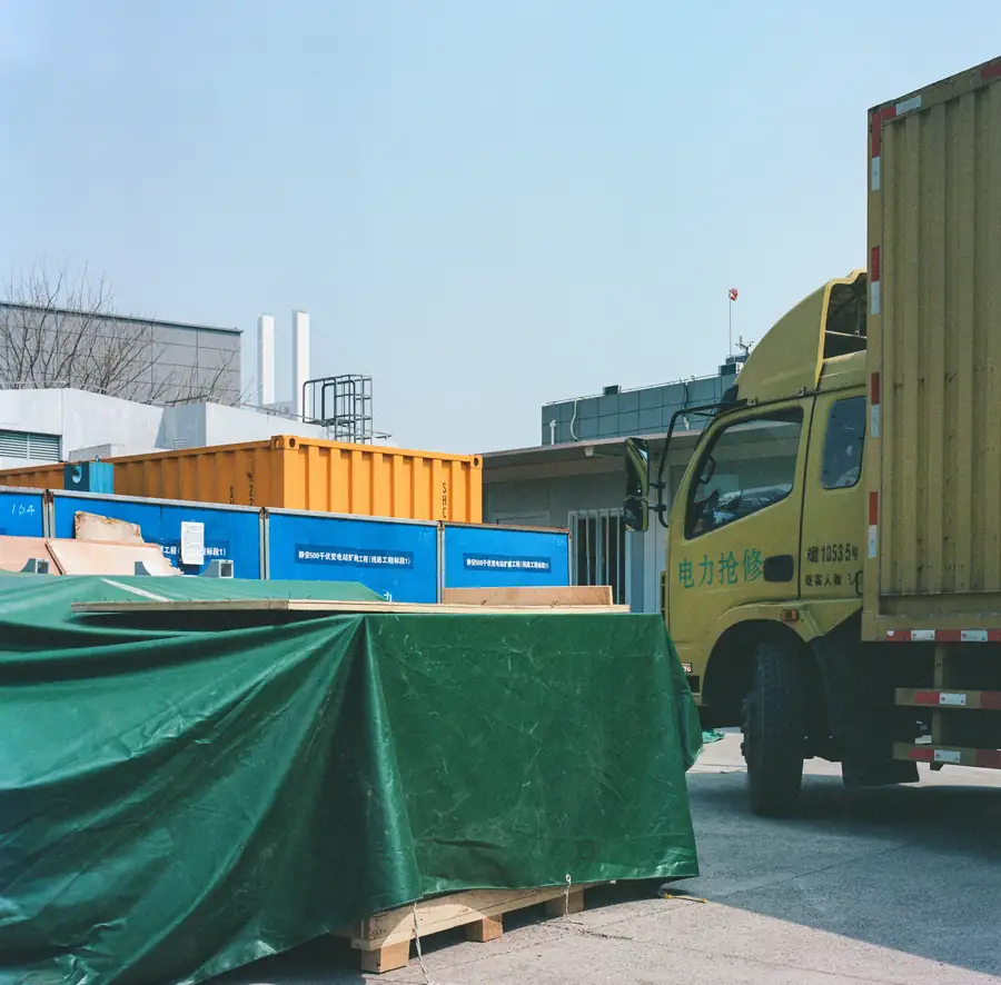A delivery truck unloading restaurant equipment