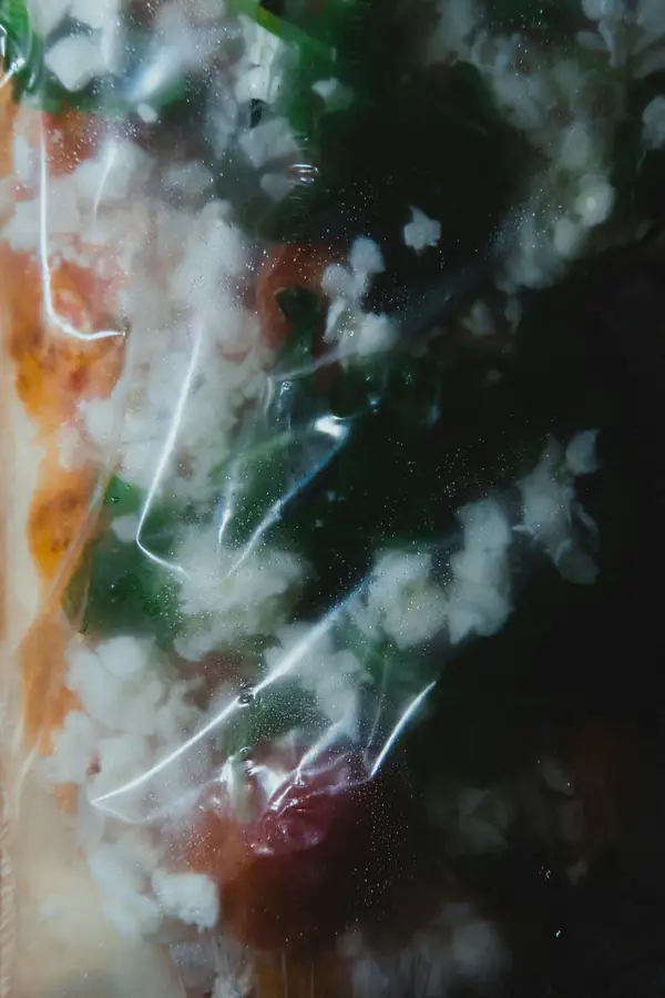 Close-up of a steaming pizza being removed from a commercial pizza oven
