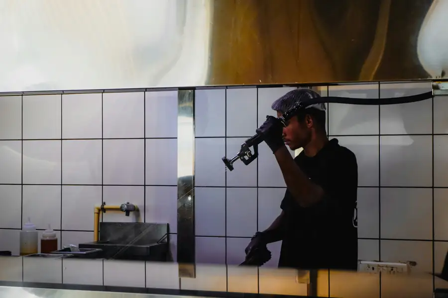 Technician installing a combi oven in a commercial kitchen