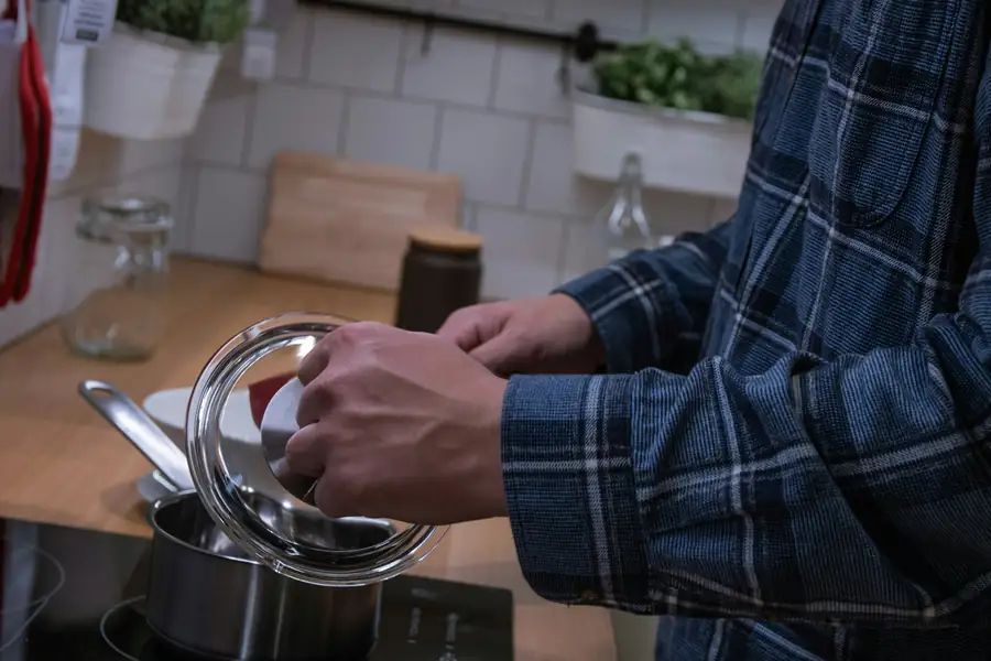 Person cleaning a food processor bowl and blade