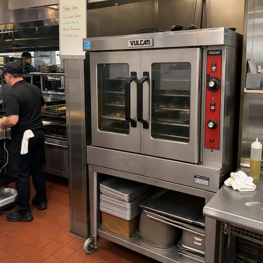 Durable stainless steel Vulcan convection oven in a bustling restaurant kitchen in English
