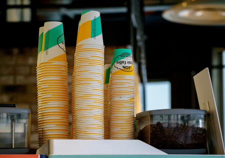 Image of eco-friendly cafe supplies such as compostable cups and utensils