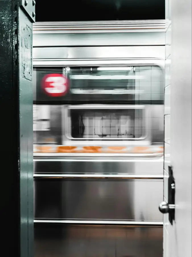 Staff cleaning and maintaining a commercial freezer interior