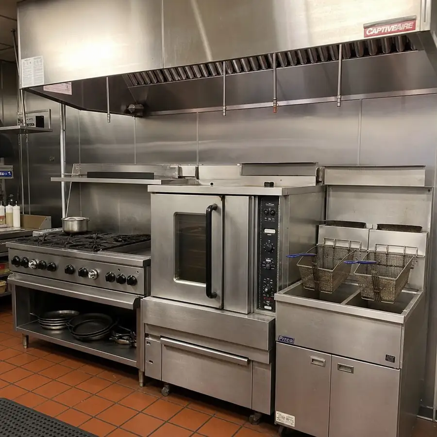 Commercial kitchen overview with stainless steel prep and cooking equipment