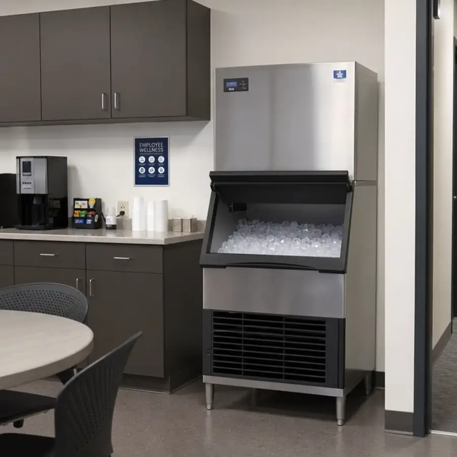 Stainless steel energy-efficient commercial ice machine with clear ice cubes in a restaurant or bar kitchen