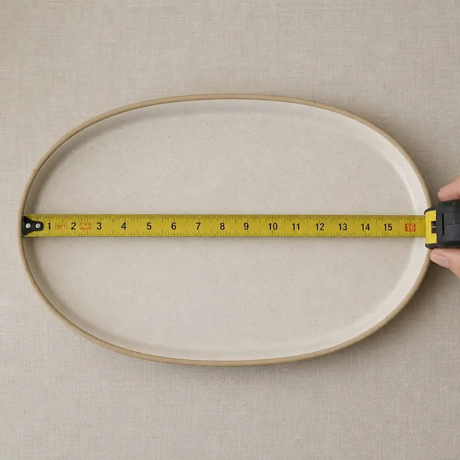 Serving platter being measured with a tape measure to confirm size before ordering multiple trays