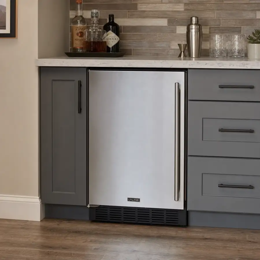 Stainless steel undercounter ice maker installed beneath a commercial kitchen counter with ice service nearby