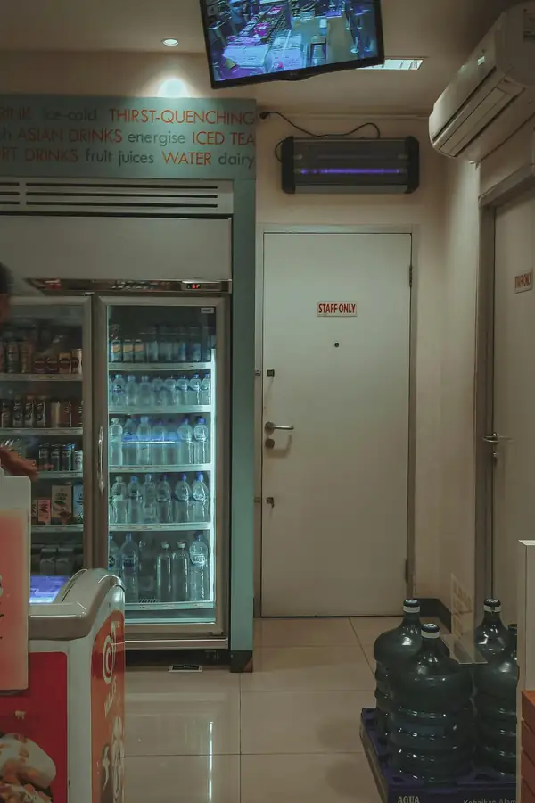 Technicians installing and maintaining a commercial walk-in refrigerator
