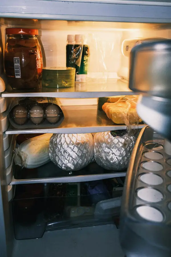 Kitchen staff accessing a walk-in refrigerator during service workflow
