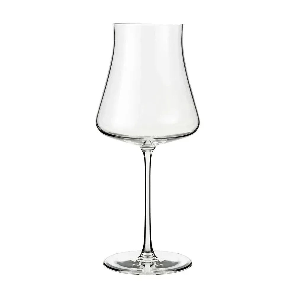 Elegant tall stemmed crystal wine glass from Libbey catching soft light with burgundy liquid reflecting warm tones on a polished wooden table.
