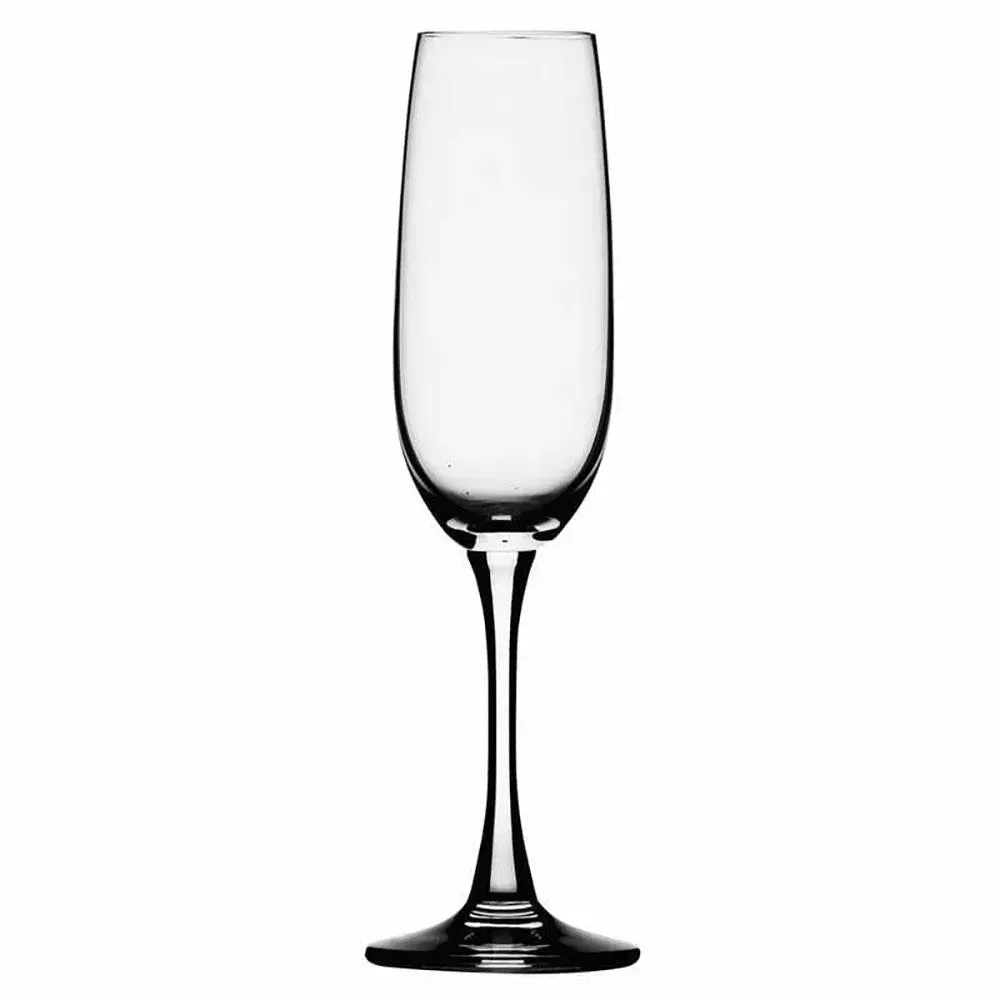 Slender crystal champagne flute from Libbey catching golden effervescence beside strawberries and cream on a marble tabletop.
