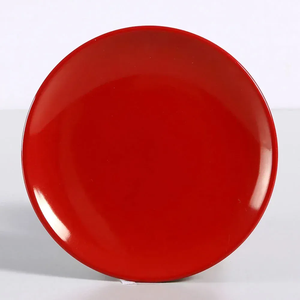 Large round melamine coupe plate in a vibrant, glossy red from Yanco China, a bold and durable choice for making a statement with your food.