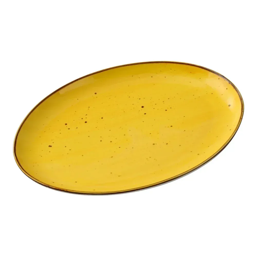 Oval coupe plate by Yanco China with a rustic reactive yellow glaze, a stylish choice for presenting side dishes in vibrant restaurants.