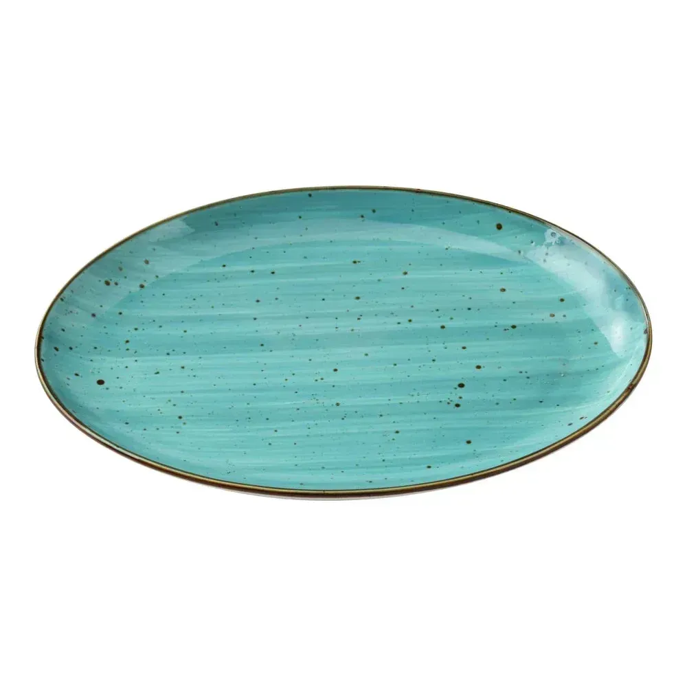 Medium oval coupe dinner platter in handcrafted turquoise reactive glaze from Yanco China, ideal for showcasing main courses with rustic elegance.
