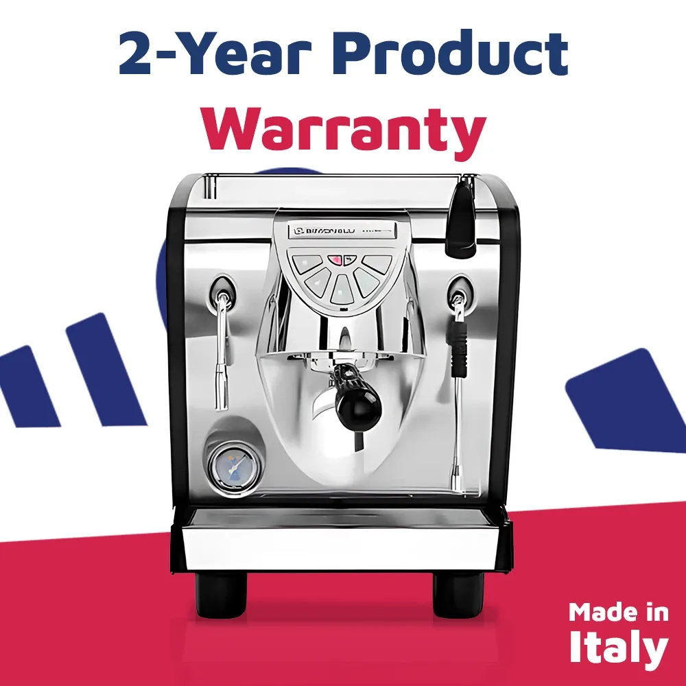 Nuova Simonelli compact espresso machine in brushed metal with touch panel and lit brew group sits on marble counter with cups ready to brew.