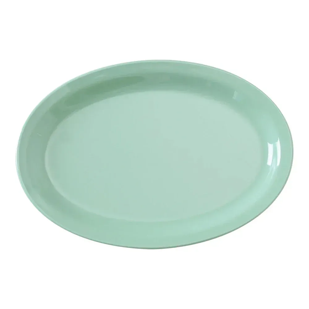 Yanco China green melamine oval platter with narrow rim for professional plating in restaurants, cafes, or catering venues. Dishwasher safe.