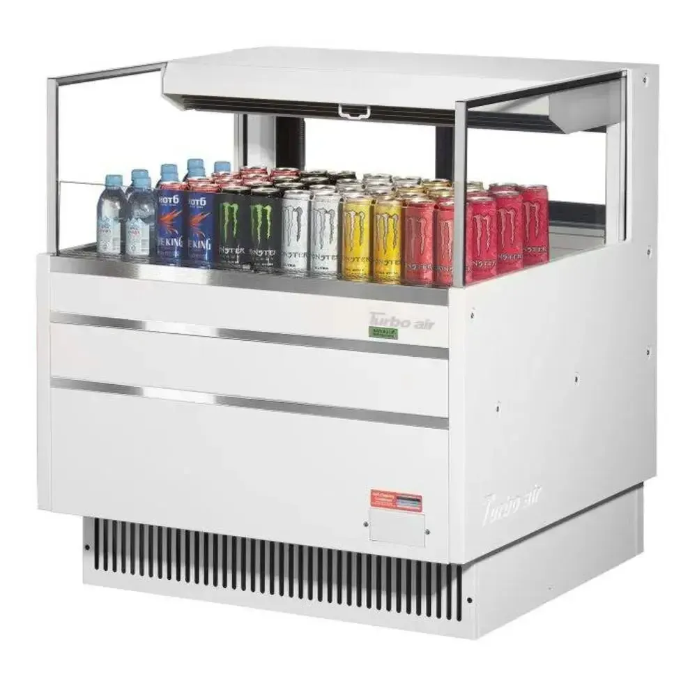 Low profile horizontal open merchandiser by Turbo Air with a compact width, triple shelf under canopy, LED lighting, and a front grille.