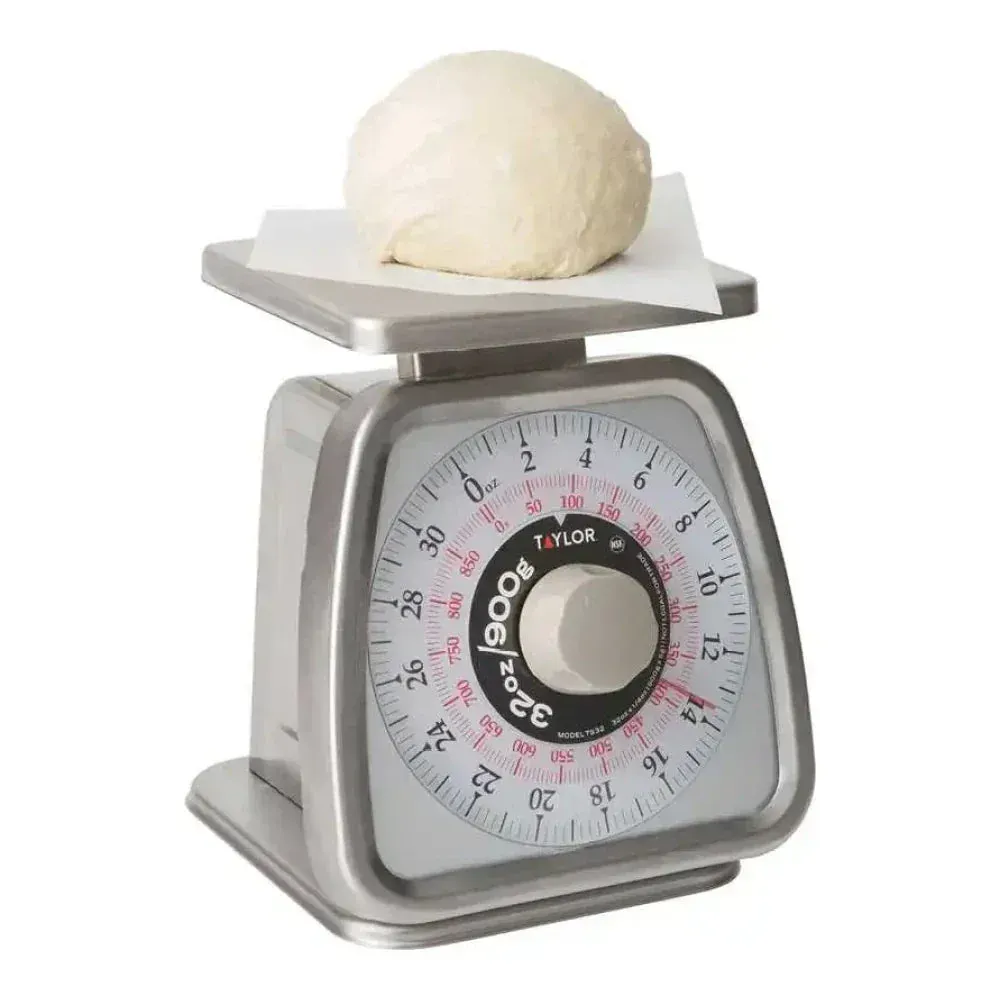 Taylor mechanical portion control scale with rotating dial, compact and accurate for consistent food portioning in restaurants or bakeries.