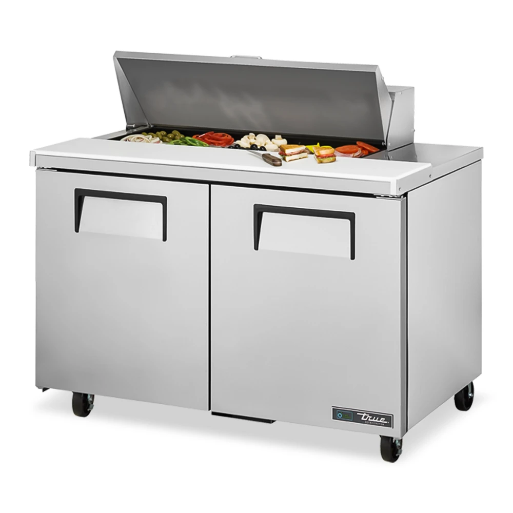 True sandwich prep table with two doors and refrigerated base, keeping ingredients fresh and ready for high-volume production.