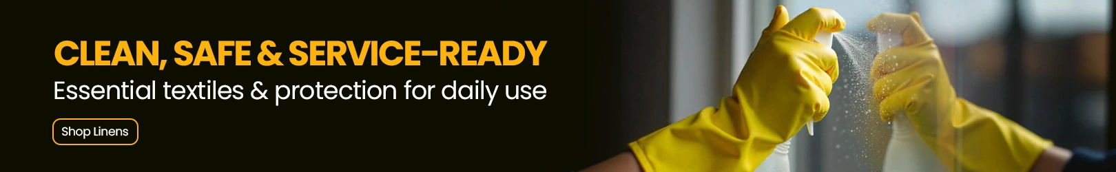 Person wearing bright yellow cleaning gloves spraying and wiping a glass surface, with a blurred indoor background for a clean, safe service setting.