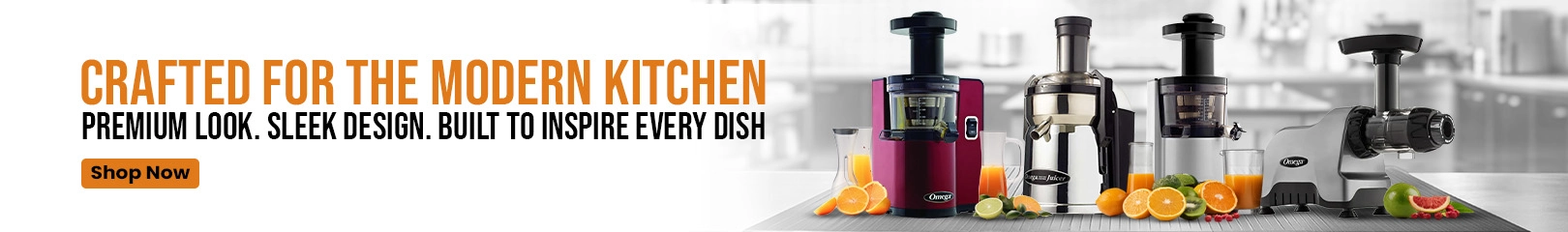 Four Omega juicers in various designs and colors displayed on a kitchen counter with fresh oranges, limes, apples, and juice glasses.